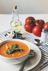 Vegetable tomato soup in a white bowl top and side view