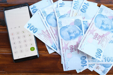 Close up, Moneys with smart phone's calculator to make economy, Turkish liras