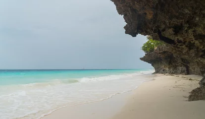 Fotobehang Nungwi Strand, Tanzania Nungwi rocky sand beach washed with turquoise Indian ocean waves. White sand sandbank beach landscape on Zanzibar island, Tanzania. Exotic countries travel concept