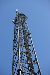 Fototapeta na wymiar telecommunication antenna with blue sky as background