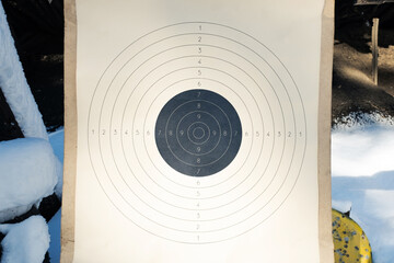 Blank paper target with shooting range numbers. A round, clean target with a marked bull's-eye for shooting practice on the range