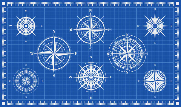 Set of isolated white marine wind roses silhouettes on blue background. Compass vector navigation symbol illustrations. Elements for design. Blueprint background. Vector illustration.