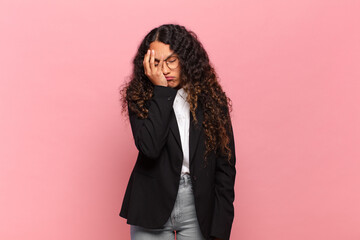 young hispanic woman feeling bored, frustrated and sleepy after a tiresome, dull and tedious task,...