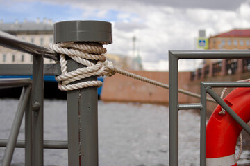 rope on the fence on Neva river terminal