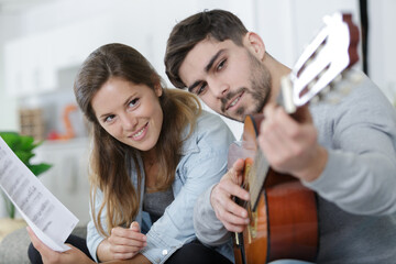 lady watching boyfriend play the guitar