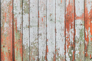 Light blue red and green weathered wooden background with cracked paint.