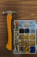 Hammer and Set of Nails on a Wooden Background; Building, Carpentry, Work Themes