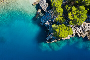 Fototapeta na wymiar Mediterranean sea. Aerial view on water and rocks during sunset. Vacation and adventure. Beach and blue water. Top view from drone at beach and blue sea.