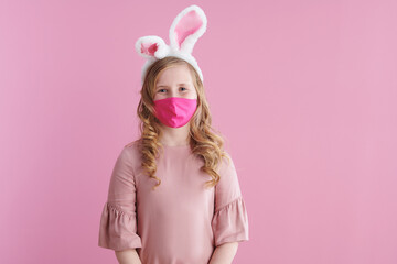 stylish girl with long wavy blond hair on pink