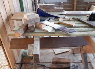 wood carpentry table with hand saw and sawn boards. repair and construction concept.