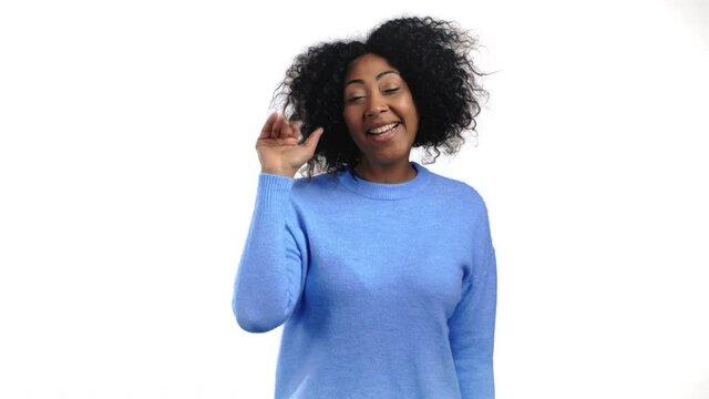 African friendly woman waving hand - goodbye, chao, adios. Parting, say bye to camera. Beautiful trendy girl waving hand on white studio background. 