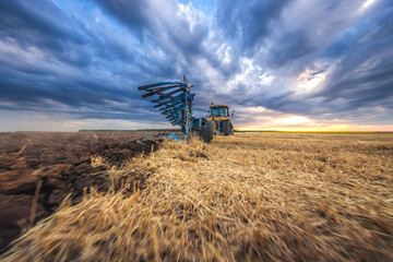 Fototapeta premium Tractor plowing the fields