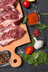 Raw pork chop steak prepare in kitchen with vegetable and spices for food and cooking concept.