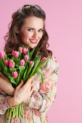 smiling elegant woman in floral dress on pink