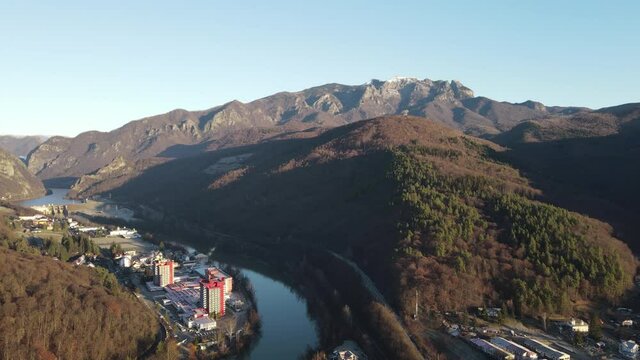 Aerial drone landscape of Calimanesti Caciulata in Valcea. Hotels near Olt River environment in mountain Olt Valley beautiful gorge river in Romania, defile carved valley near Cozia national park.