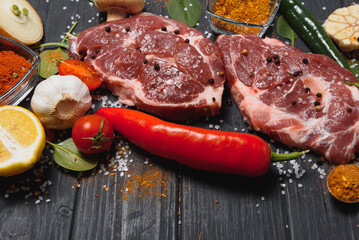 Raw pork chop steak prepare in kitchen with vegetable and spices for food and cooking concept.