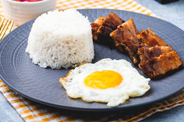Porksilog (profile shot) -is a famous Filipino meal that consists of fried rice, egg and fried pork...