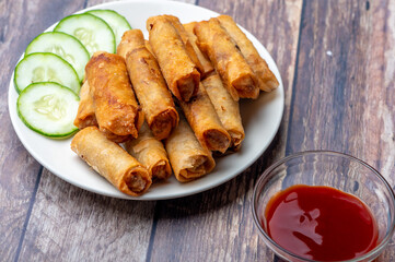 Pork Lumpiang Shanghai (ketchup front) is a Filipino favorite, its a dish usually served at parties and feasts. This is very similar to a spring roll.