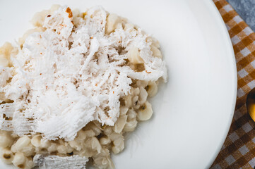 Binatog (Close Up Top) or boiled white corn kernels is a popular Filipino snack and street food. Topped with shredded coconut. Usually seasoned with salt or sugar.