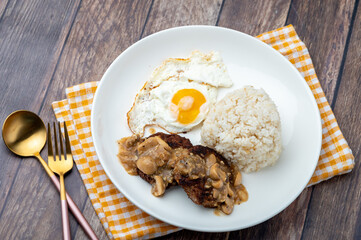 Mushroom Burger Steak Silog (zoom out)-is a famous Filipino meal that consists of burger steak covered in mushroom gravy sauce, egg and fried rice