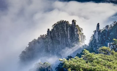 Fotobehang Huangshan Uitzicht op de wolken en de dennenboom op de bergtoppen van Huangshan National park, China. Landschap van Mount Huangshan van het winterseizoen.