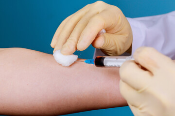 The medicine gloves nurse taking the blood into the test tube, human blood