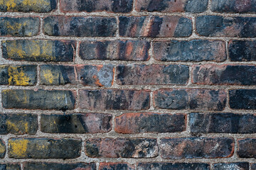 Brick wall with and colorful and chipped paint
