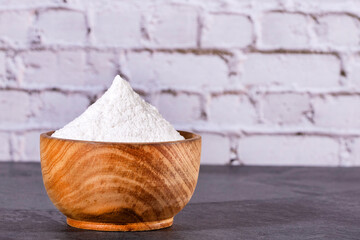 Baking soda in the wooden bowl - Text space