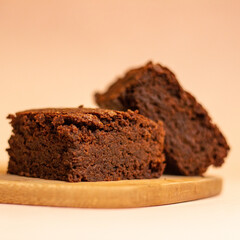 Side view of delicious gluten-free, sugar-free chocolate brownies on a wooden board. vegan...