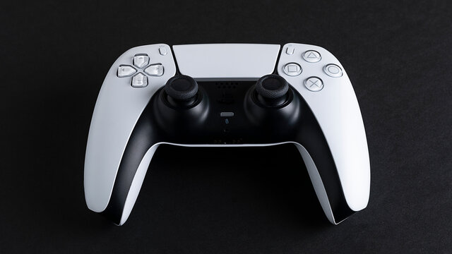 Moscow, Russia - March 8 2021: Presentation of a new product from Sony, wireless white PlayStation 5 gamepad isolated on black background