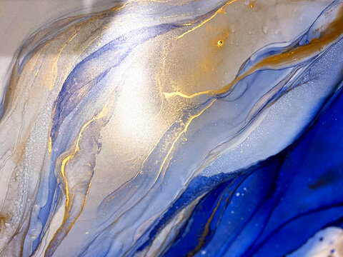 Abstract blue background. Alcohol ink blue texture. Blue fluid art backdrop. Blue with gold texture. Abstract sea art. Abstract sea or mountains landscape. Watercolor and aquarelle effect. © Luvricon