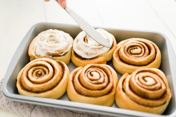 Delicious sweet rolls decorated with sugar icing