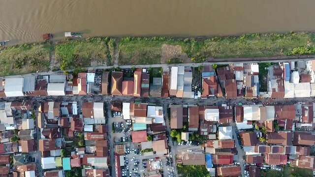 Chiang Khan, Thailand, the aerial view of the Mekong river and the riverside village that has a local road passed the residential zone 