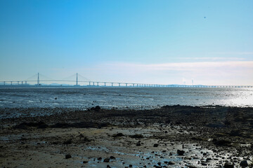 A tidal flat with a view of Incheon Bridge in the blue sky 파란하늘에 인천대교가 보이는 갯벌