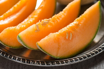 ripe melon cut into pieces on a platter
