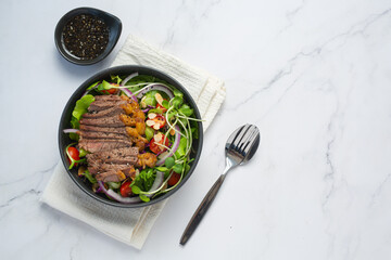 Grilled Beef Steak salad with vegetables and sauce. healthy food.