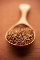 Wooden spoon with dried rooibos tea