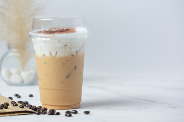 iced coffee in glass and coffee beans in glass on white background