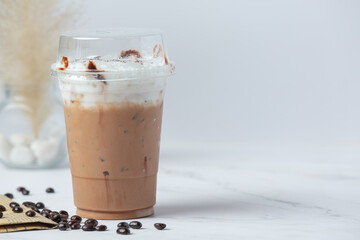 iced coffee in glass and coffee beans in glass on white background