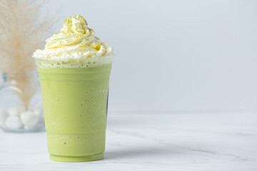 green tea smoothies with whipped cream on white background