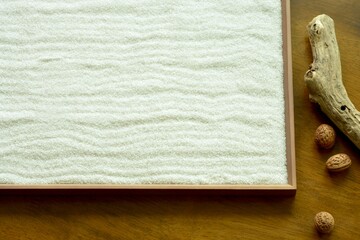 “Zen style” White sand sign board.
with Walnut and Driftwood. 
  
blurred background soft focus image.
