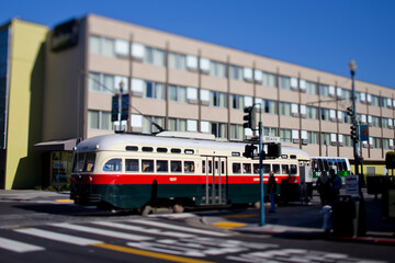 Plakat San Francisco Cable Trolley Car moves through the street California people-mover transportation. Tilt-shift lens photography effect.