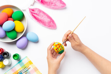 colorful Easter egg and bunny rabbit ears on table