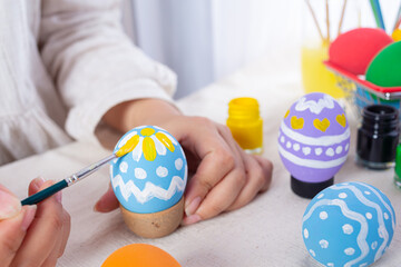 Asian young woman painting Easter eggs