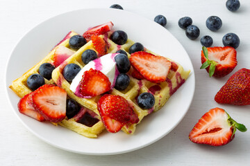 Waffles, strawberries, blueberries with yogurt