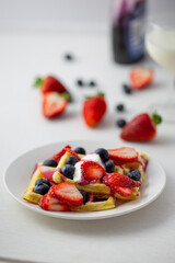 Waffles, strawberries, blueberries with yogurt