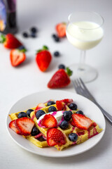 Waffles, strawberries, blueberries with yogurt