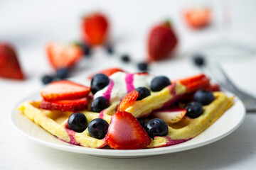 Waffles, strawberries, blueberries with yogurt