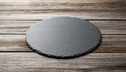Stone plate placed on a wooden background