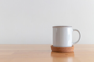 White cup of hot coffee mug on wooden table with isolate white background.